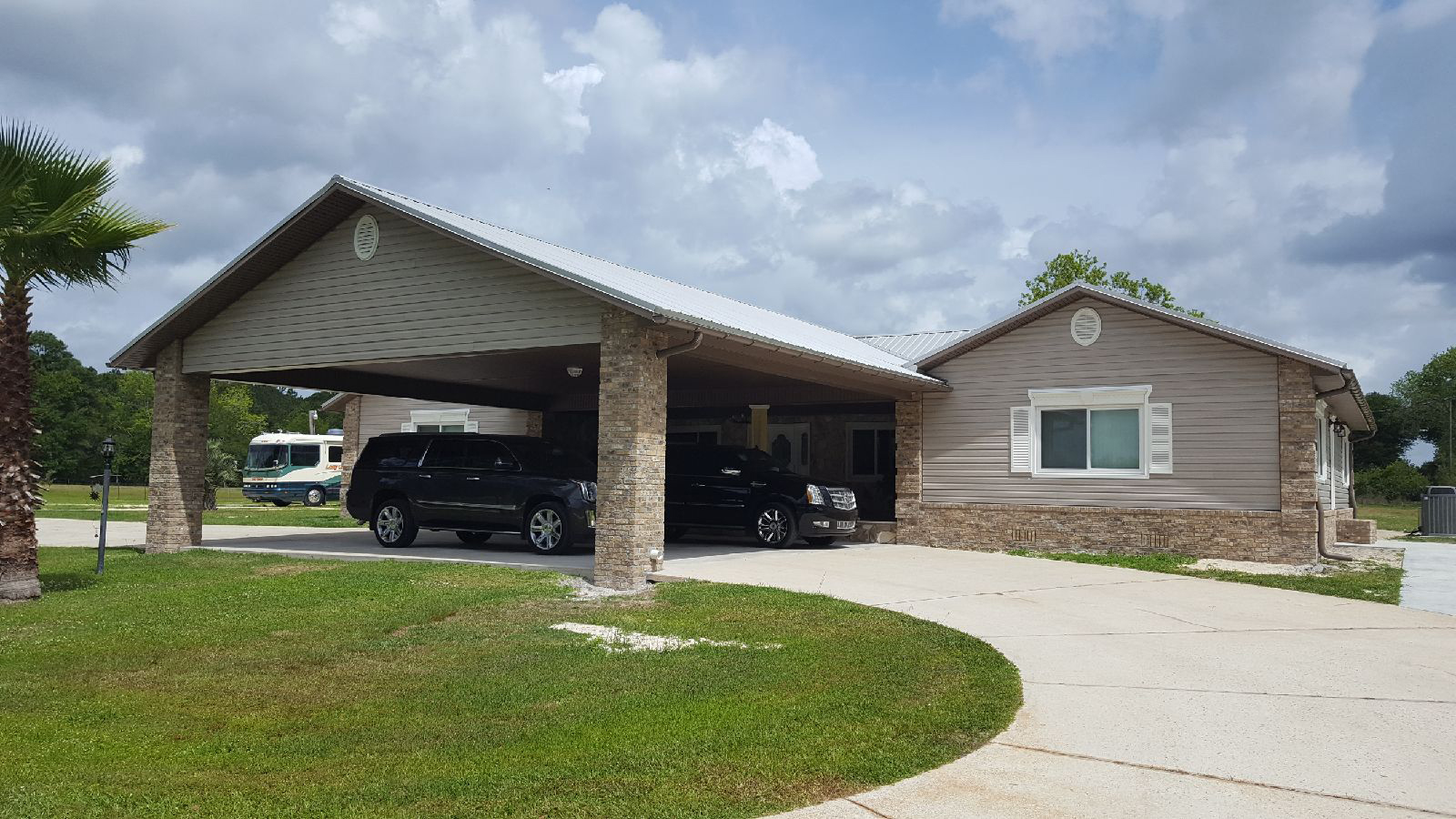 Custom Carport Driveway leading to home with large carport