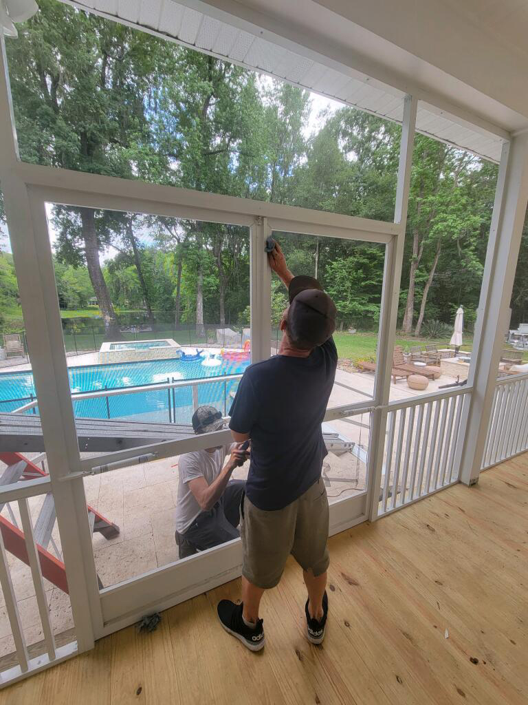 workers installing screen enclosures