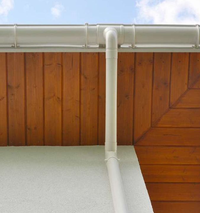 view of wooden soffit and white gutter pipe