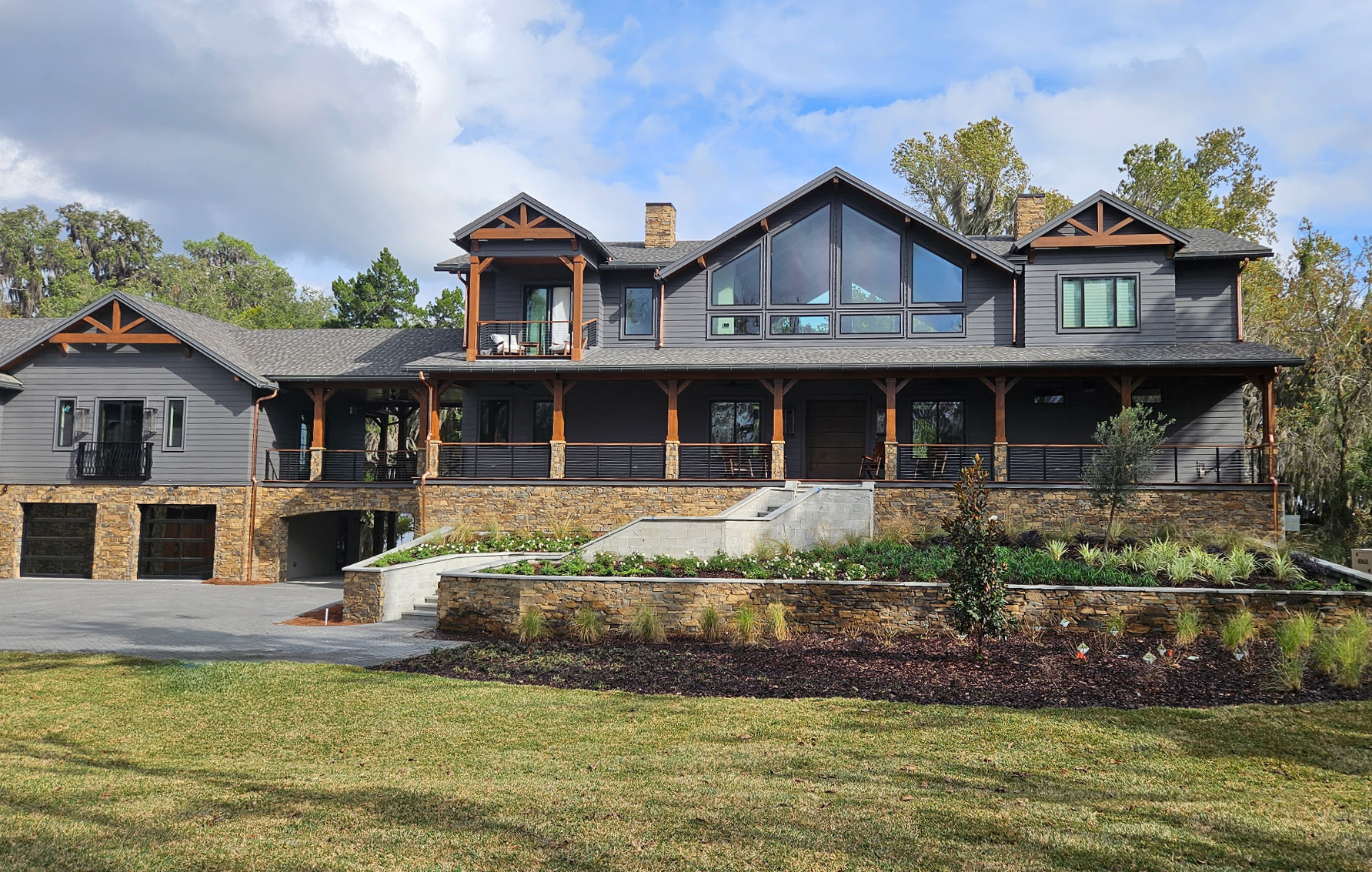 Exterior of multi-level home featuring seamless gutters and expansive windows