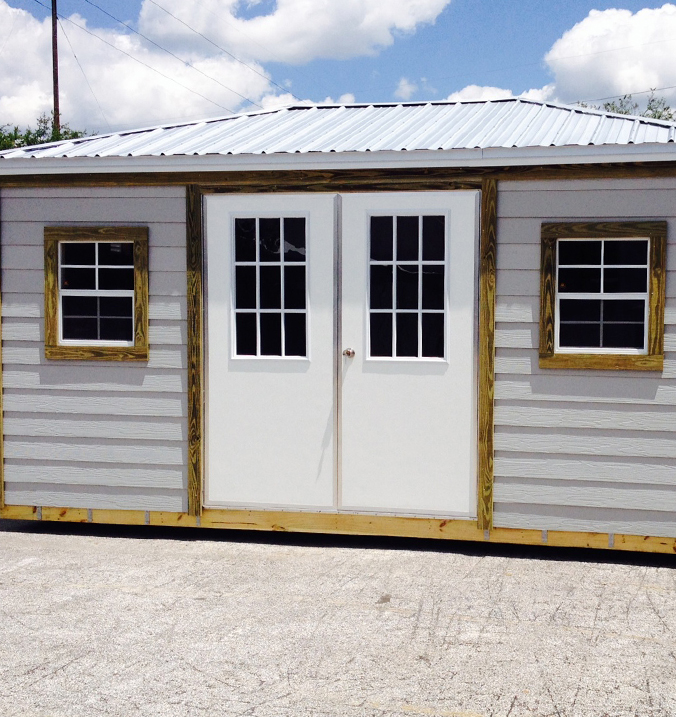 Storage shed with french doors and two windows